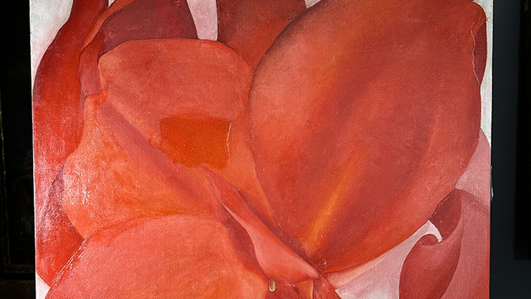 An abstract painting of red flowers; one section just left of center is slightly shinier than the rest.