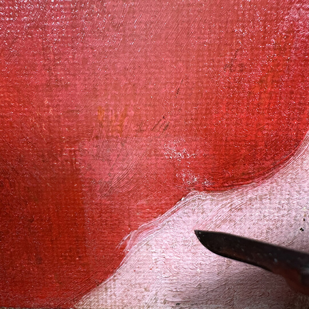 A close-up of a scalpel next to the surface of an oil painting pointing to what looks like clumps of white fuzz.