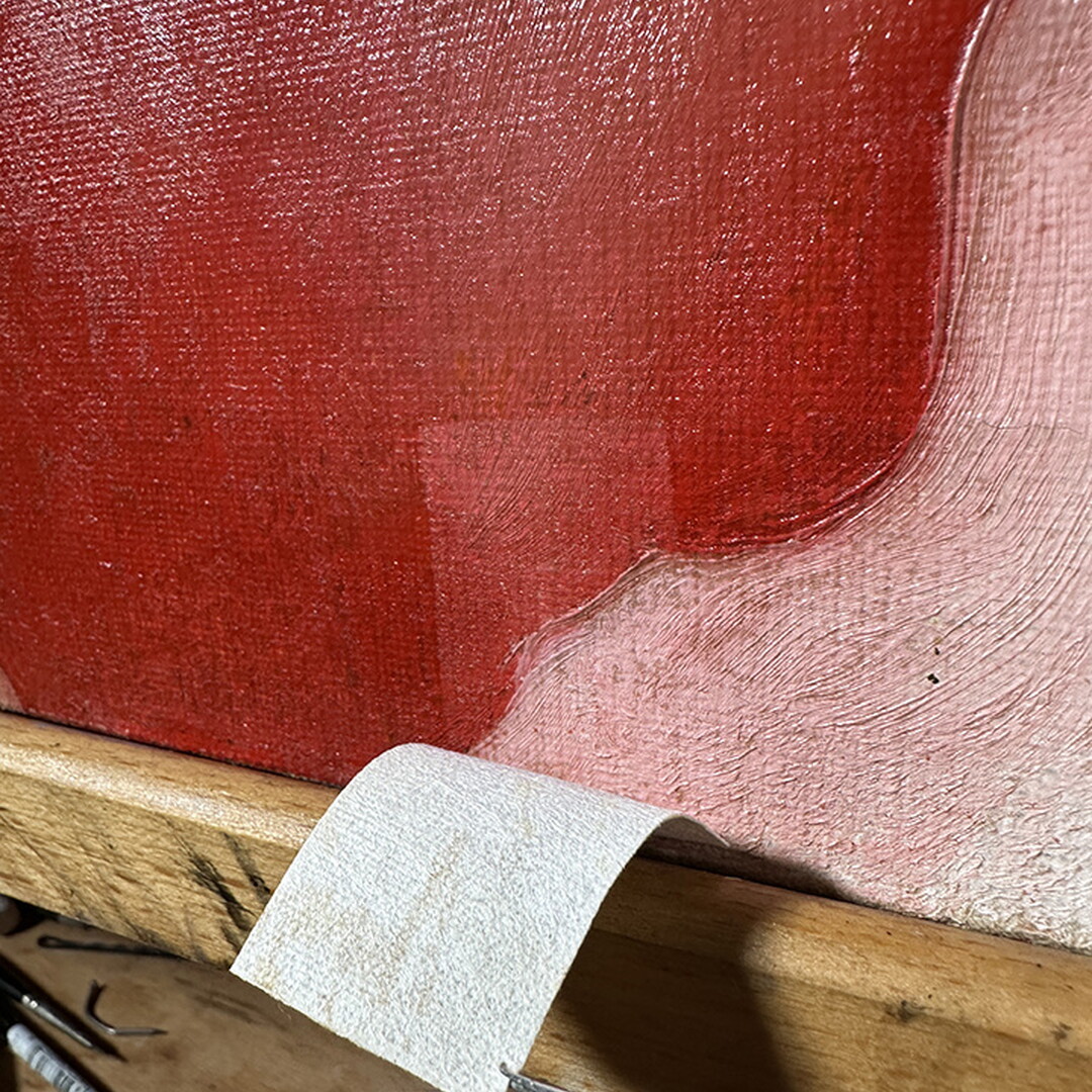 A close-up of an oil painting with a lighter shape on the surface where a rectangular piece of adhesive had been.