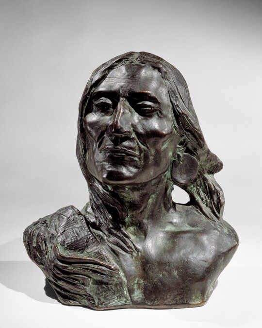A bronze bust of an Indigenous person.