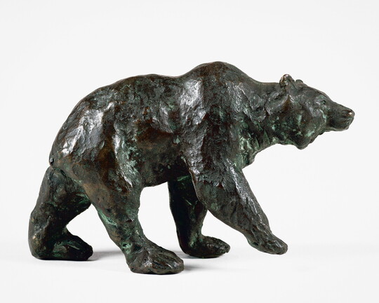 A bronze sculpture of a walking bear.