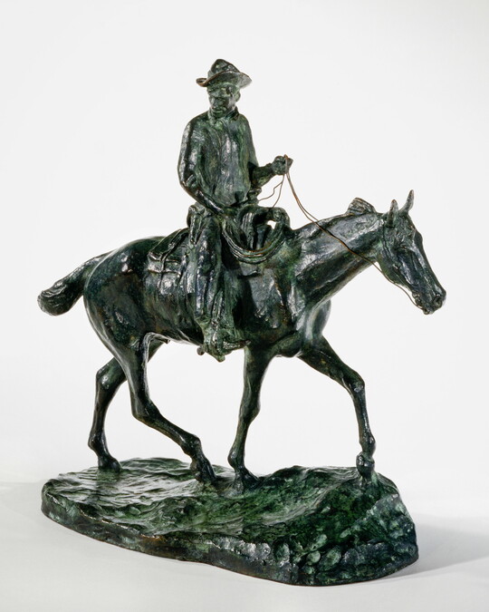 A bronze sculpture of a man wearing a cowboy hat seated on a walking horse.