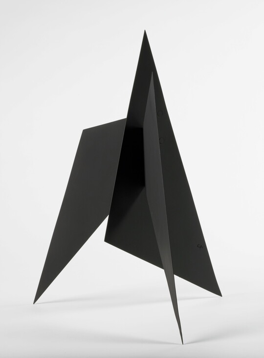 A black abstract tabletop sculpture with sharp points.