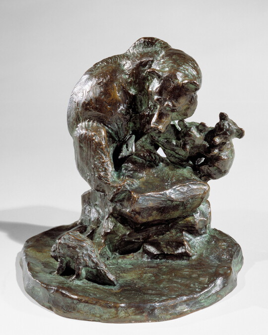 A bronze sculpture of a mother bear and her two cubs huddled on a rock as a porcupine walks past.