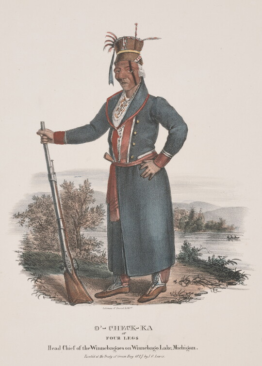 A color print of an Indigenous man wearing a tall hat decorated with feathers and ribbons, black stripe on one side of his face, long blue jacket with red trim, posing with a long rifle, stock resting on the ground.
