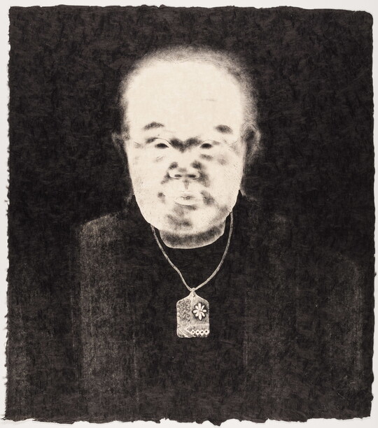 A black-and-white print of an abstracted man with Asian features, a bright white face, and wearing a delicate patterned necklace all on a black background.