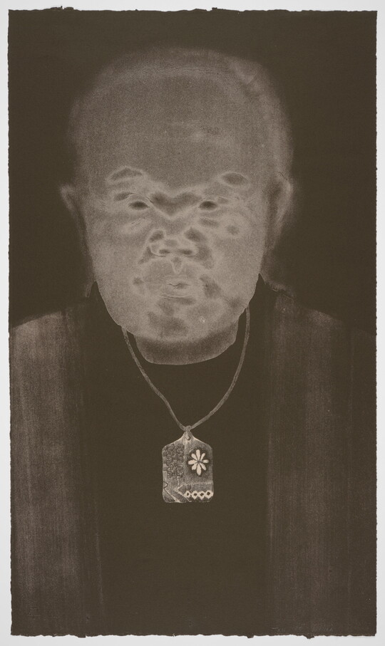 A black-and-white print of an abstracted man with Asian features, a gray face, and wearing a delicately patterned necklace all on a black background.