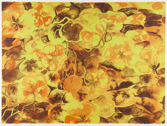 An abstract color print of intertwined yellow and orange flowers against brown rocks.