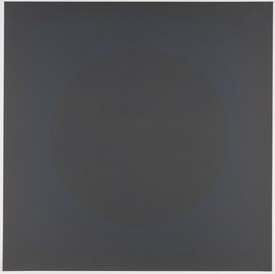 A color print of a circle defined by faint a blue spattered outline in the center of a dark gray square.