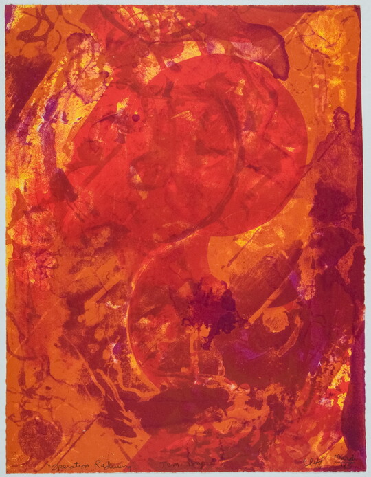 An abstract color print of swirls of red, orange, and yellow.