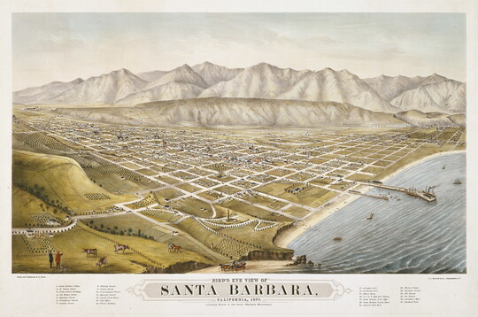 A color print of an aerial view of a gridded city along a shoreline with mountains in the distance.