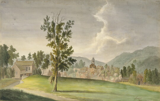 A watercolor landscape of a farmhouse on a hill that overlooks a city nestled in a valley between hills.