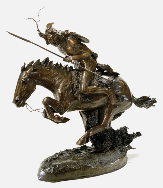 A bronze sculpture of an Indigenous man holding a spear and a crop while riding a galloping horse.