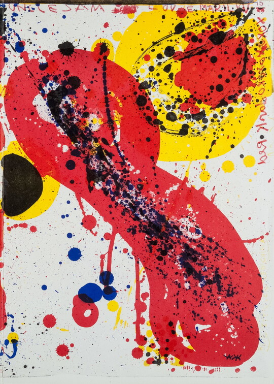 An abstract color print with splatters and splotches of red, yellow, blue, and black.