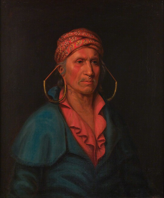 A portrait painting of a Native American man from the waist up wearing a colorful turban, large earrings, a bright red shirt and blue jacket.