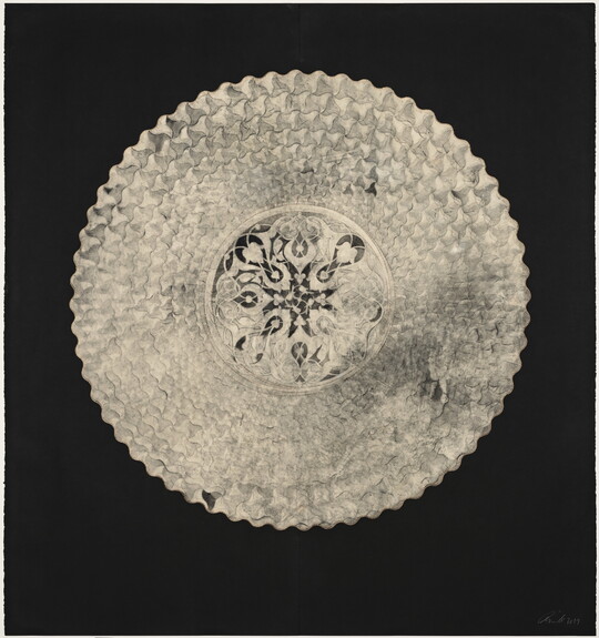 An abstract, mostly flat creation of a white circular shape filled with intricate geometric patterns that resemble lace on a black background.