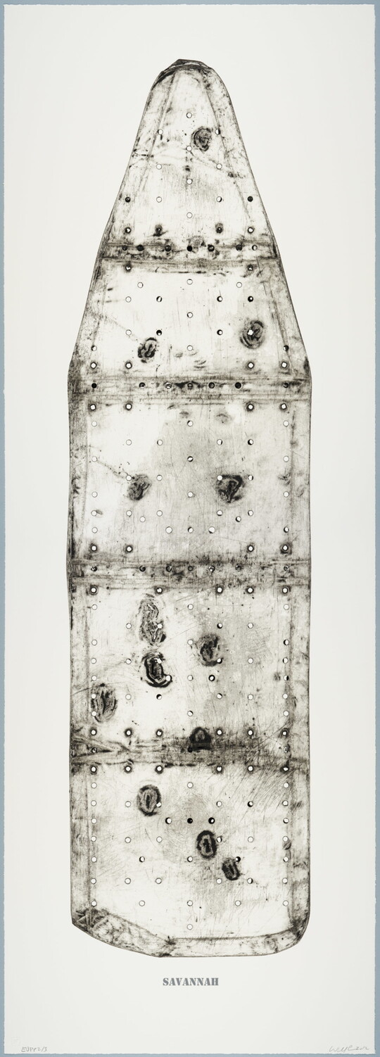 A black-and-white print of an ironing board filled with holes and dents, showing the shadows of its supporting structure, and with the word "SAVANNAH" below the image.