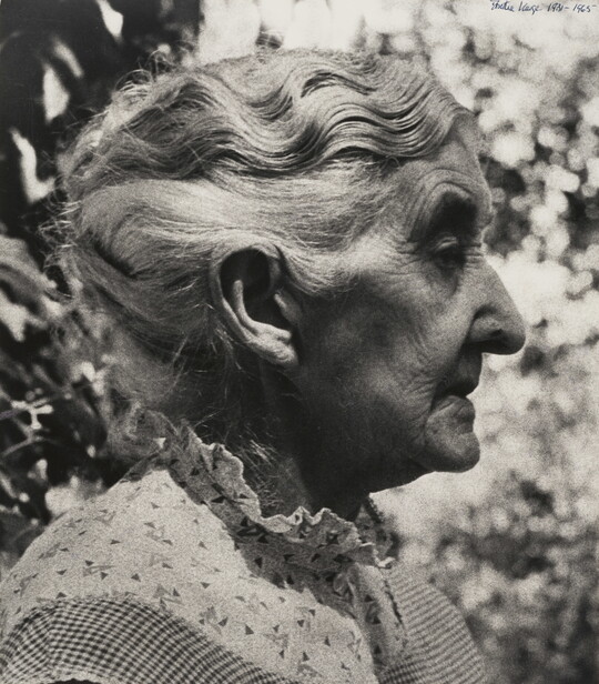 A black-and-white photograph of an elderly White woman in profile.
