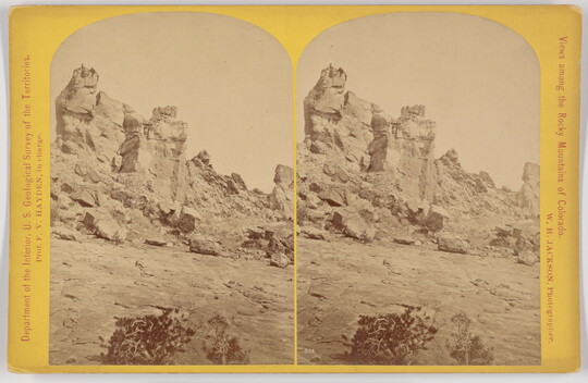 Two almost identical side-by-side sepia-toned photographs of a tall rock formation.
