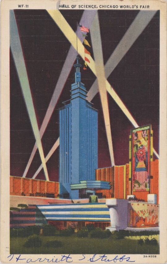 A color postcard of a tall, modern skyscraper illuminated by beams of light.