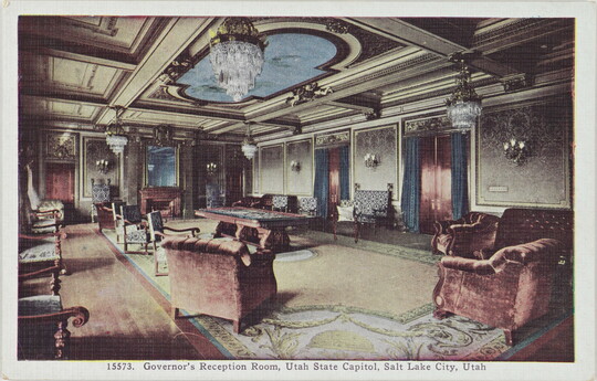 A color postcard of a richly-decorated interior space with chandeliers and velvet chairs.