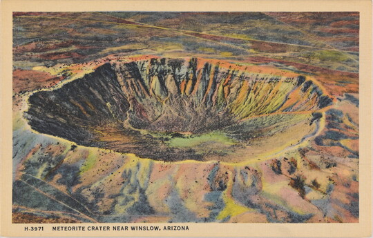 A color postcard of a bird's eye view of a large crater in a rocky desert landscape.