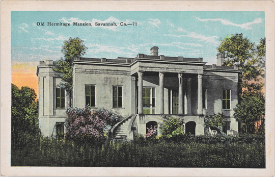 A color postcard of a white mansion with lush flowers and greenery.