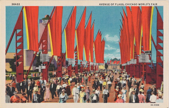 A color postcard of crowds of people walking down a large pathway flanked by bright red flags on a clear, blue day.