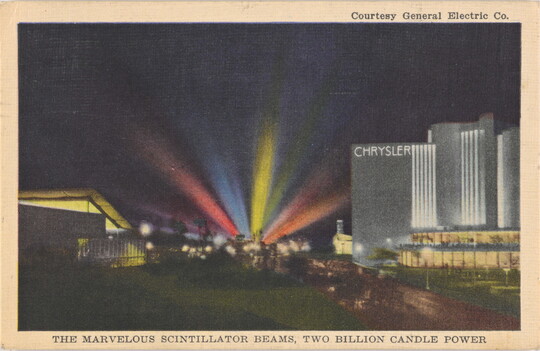 A color photograph postcard of a nighttime cityscape with colorful beams of light shining from the horizon.