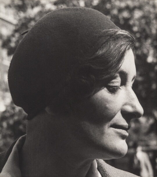 A black-and-white portrait photograph of a White woman in profile wearing a beret.