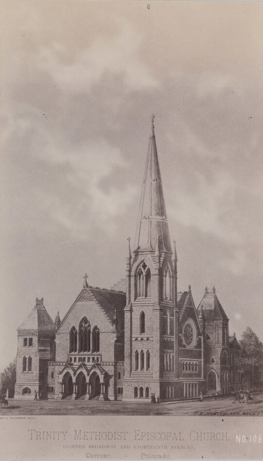 A black-and-white photograph of a stone church with lancet windows and tall spires.