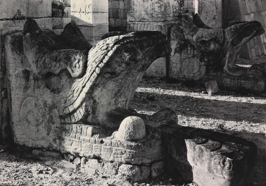 A black-and-white photograph of an ancient stone architectural embellishment in the form of an open-mouthed beast.