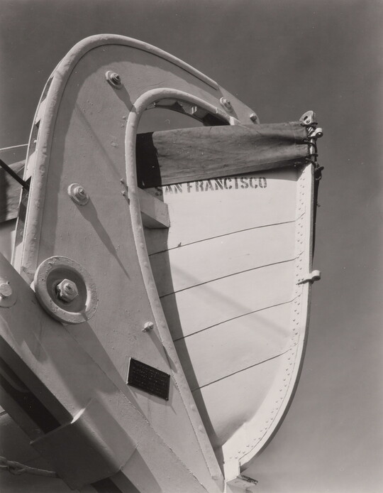 A black-and-white photograph of a lifeboat stern and its mount with the words "San Francisco" painted on the hull.