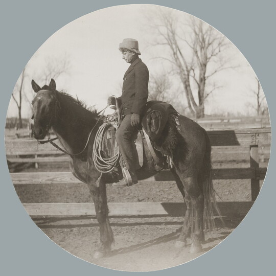 A circular black-and-white photograph of a White man on horseback in profile.