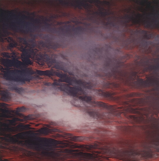 A color photograph of blue, pink, and orange clouds at sunset.