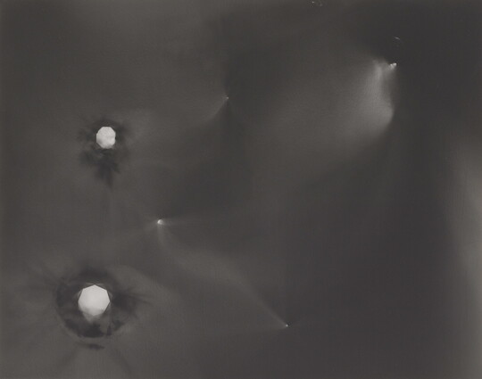 An abstract black-and-white photograph of foggy star-like constellations against a black background.