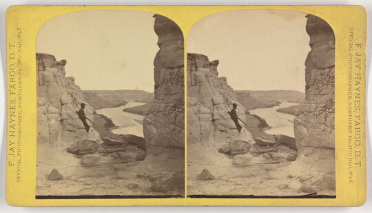 Two side-by-side, black-and-white photographs of a cowboy with a rifle leaning against rock formations in a river valley.
