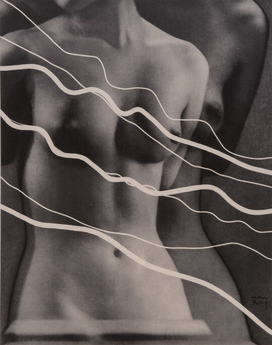 A black-and-white photograph of a double-exposed White nude female torso with several wavy lines layered in front.