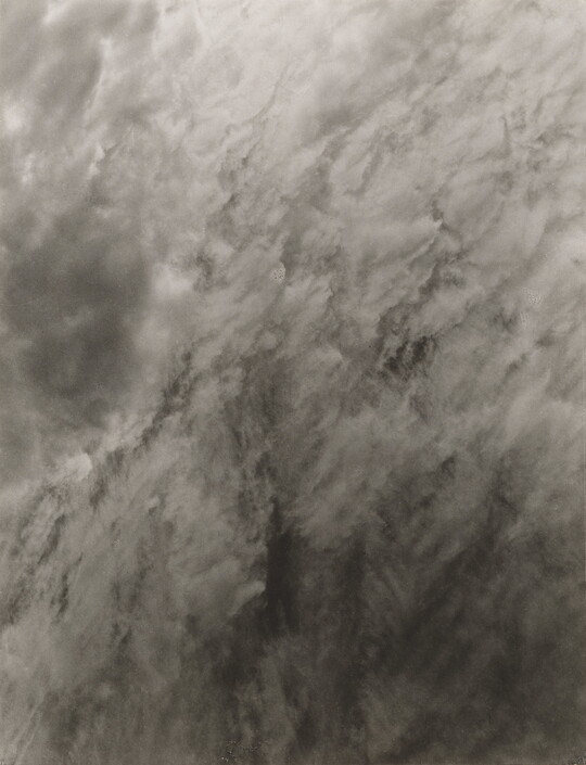A black-and-white abstract photograph of clouds or smoke.
