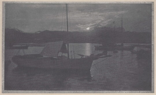 A black-and-white photograph of sailboats with lowered sails in a calm body of water, with a low sun peeking through the clouds near the horizon.
