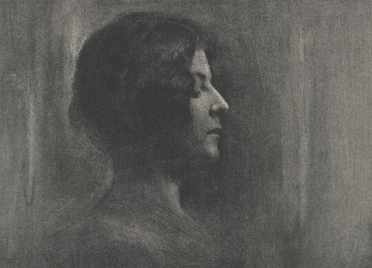 A black -and-white portrait photograph of a young White woman in profile, eyes closed.