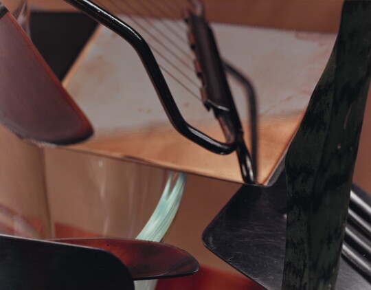 A close-up, color photograph of everyday kitchen implements arranged in an abstract composition.