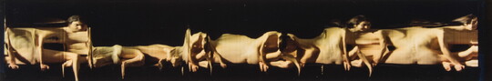 A horizontal, color photo of a nude White woman moving from position to position against a black background to create an abstract composition.