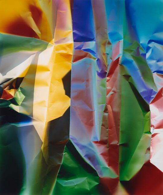 A color photograph of what looks like crinkled paper in yellow, blue, green, and red.