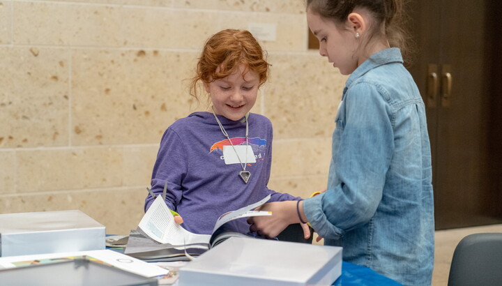 Two children working on an art project in the Carter's Atrium.