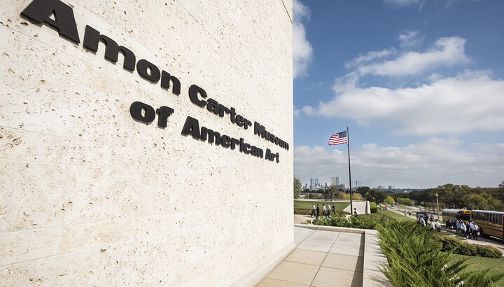 The outside wall of the Carter showing the name of the Museum and a flag on a flagpole in the distance.