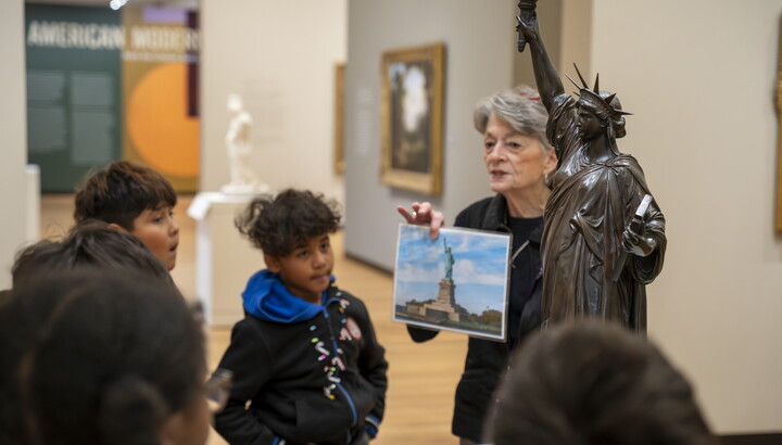 A Carter educator discusses a sculpture with students in a Carter gallery.