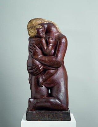 A wood sculpture of a kneeling nude woman holding a child in her arms.