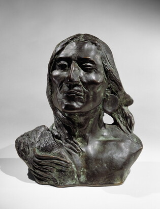 A bronze bust of an Indigenous person.