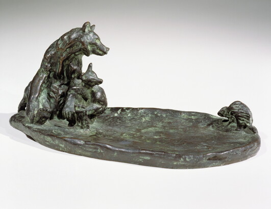 A bronze sculpture of a mother bear and her cub keeping a safe distance from a porcupine.